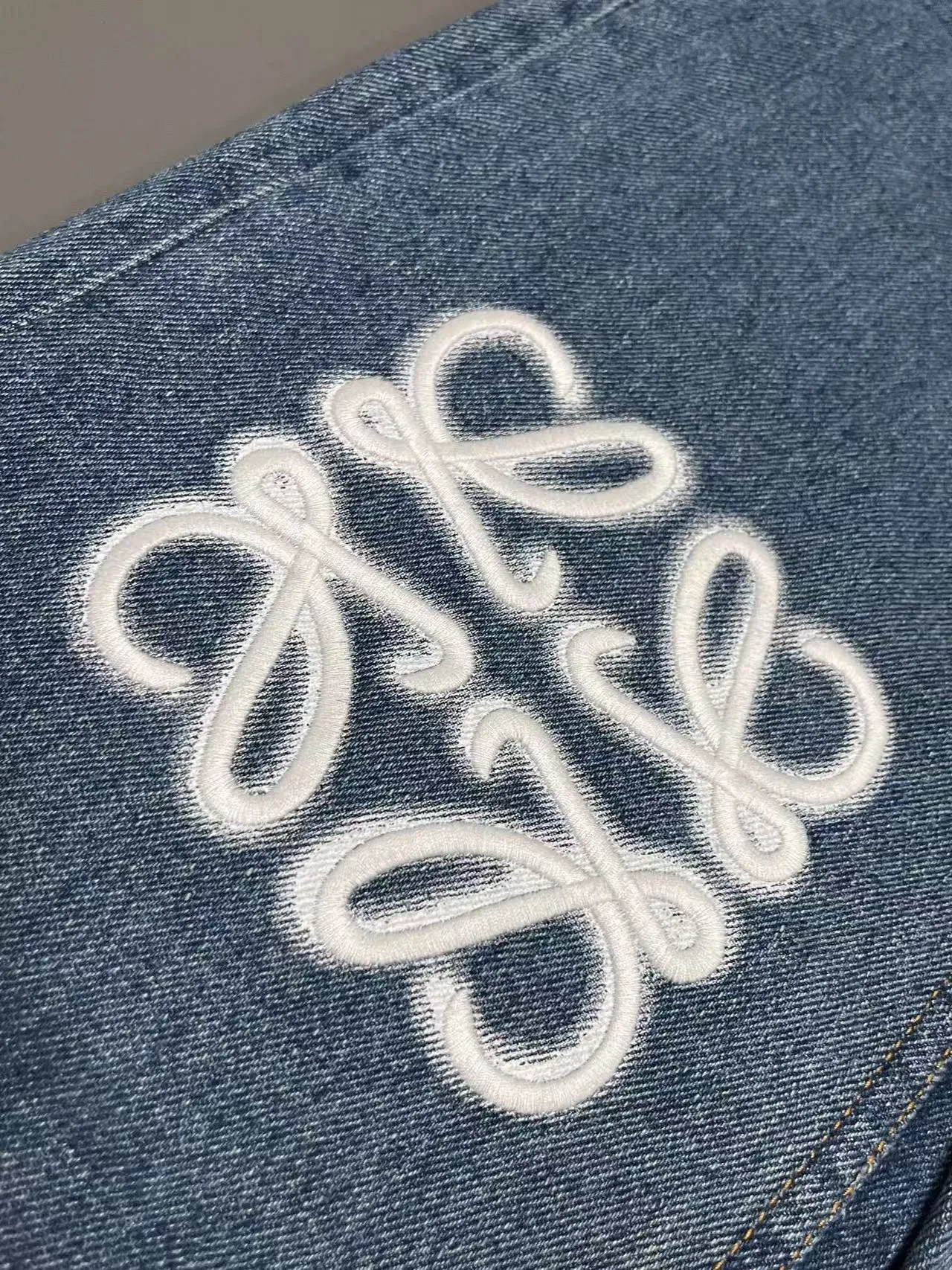 Jeans with embroidered logo at knee