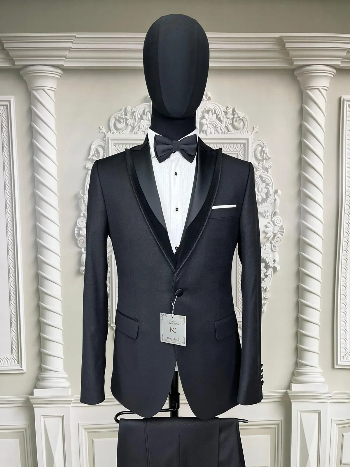 Single Button Three Piece Tuxedo Suit with Contrasting Black SatinLapel, matching bow tie and Black Pants.