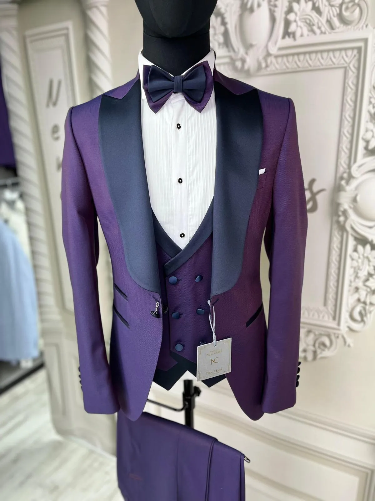 Single Button Three Pieces Tuxedo Suit with contrasting green velvet Lapel, matching bow tie and Black Pants.