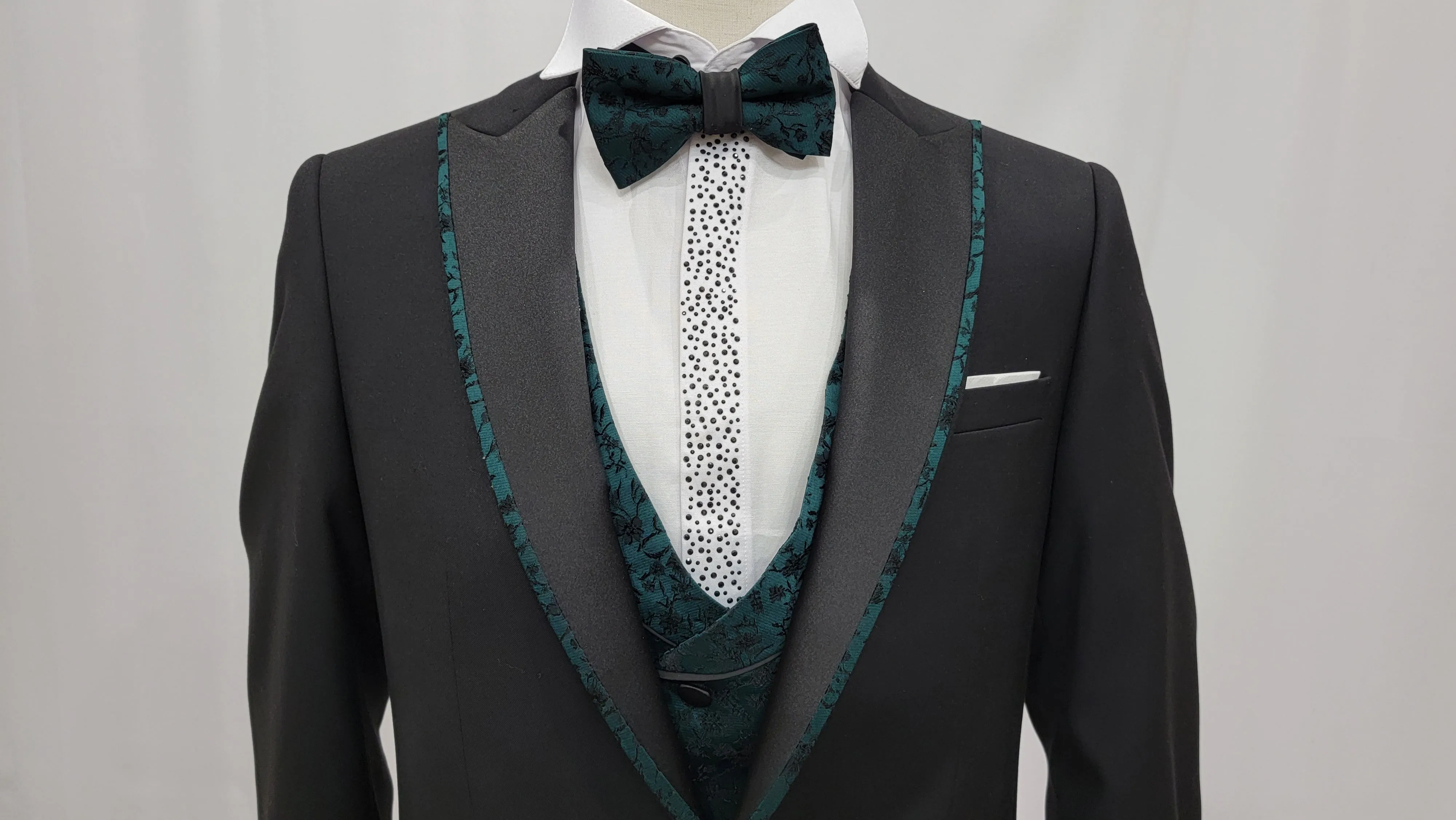 Three-Piece Tuxedo Suit with Contrasting green tapered accent, matching bow tie and Black Pants.
