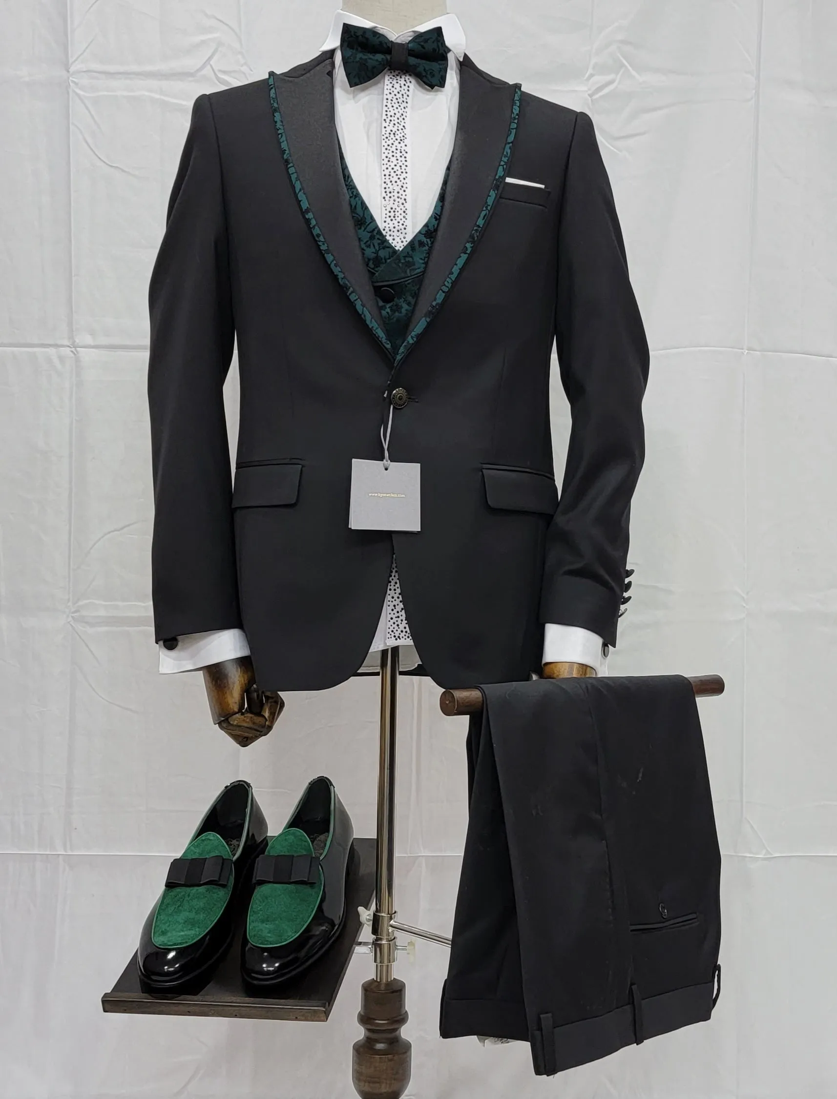 Three-Piece Tuxedo Suit with Contrasting green tapered accent, matching bow tie and Black Pants.