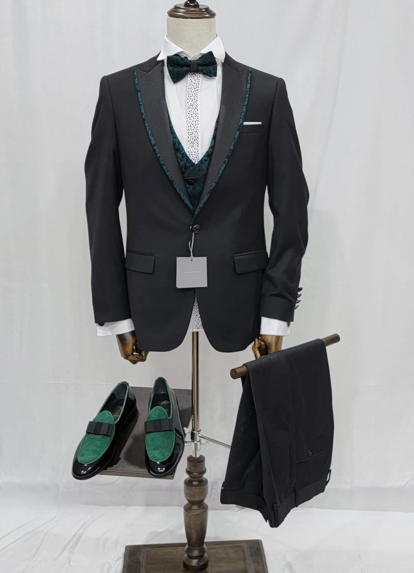 Three-Piece Tuxedo Suit with Contrasting green tapered accent, matching bow tie and Black Pants.