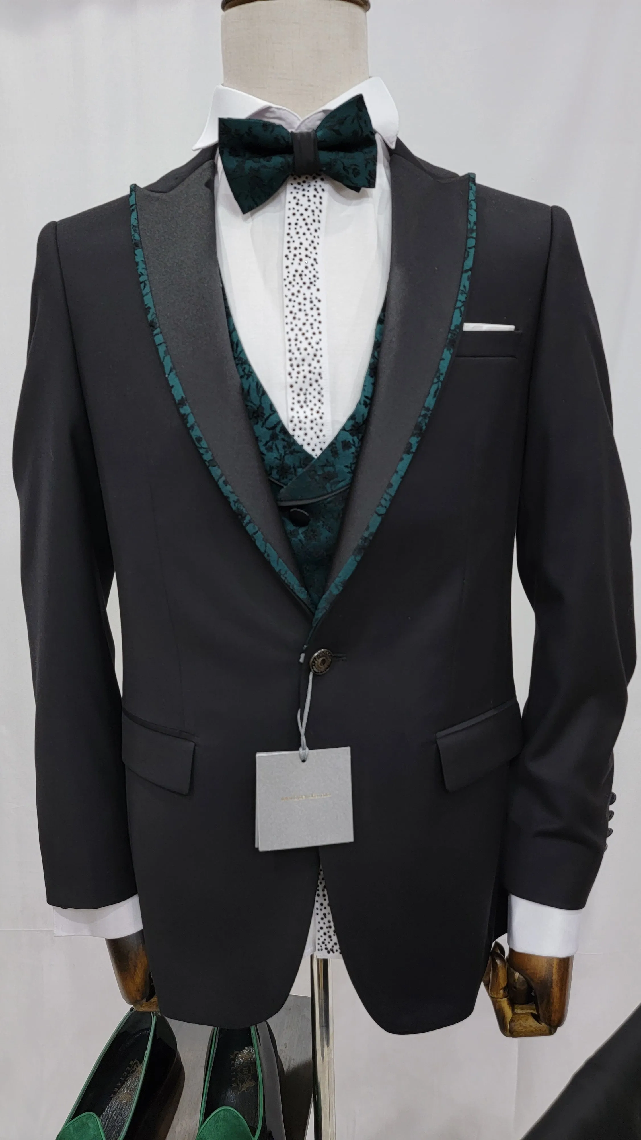 Three-Piece Tuxedo Suit with Contrasting green tapered accent, matching bow tie and Black Pants.