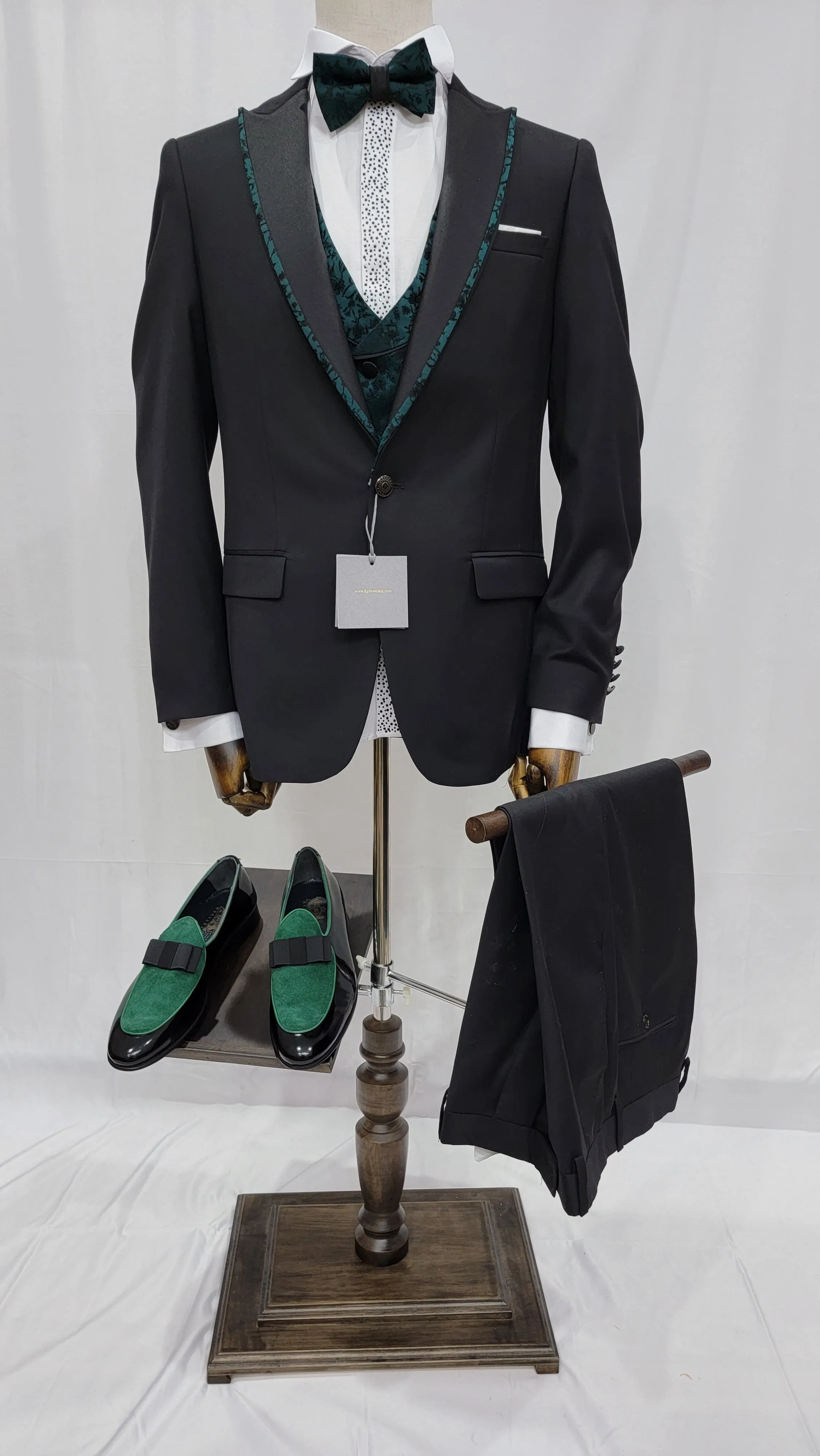 Three-Piece Tuxedo Suit with Contrasting green tapered accent, matching bow tie and Black Pants.