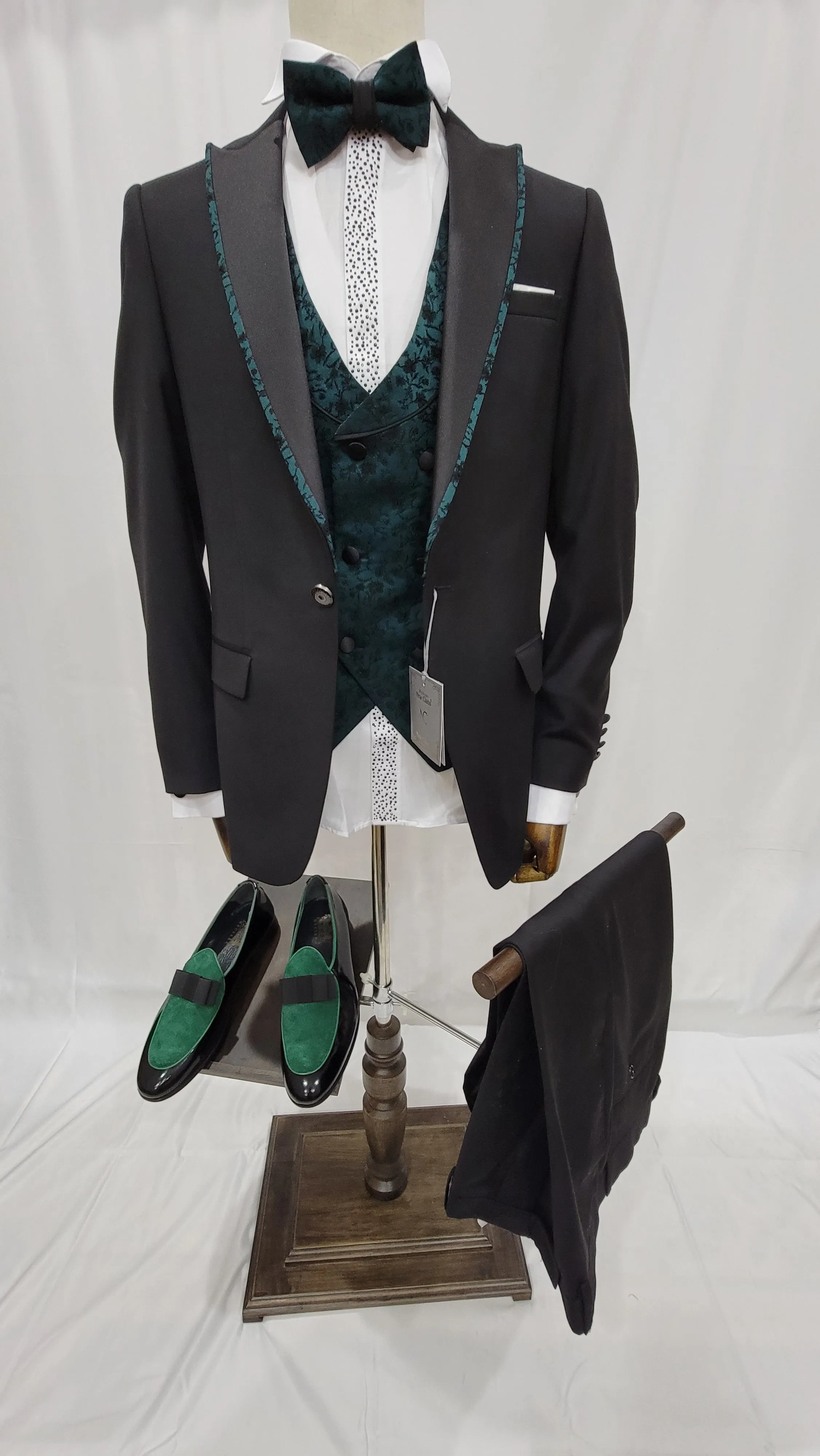 Three-Piece Tuxedo Suit with Contrasting green tapered accent, matching bow tie and Black Pants.