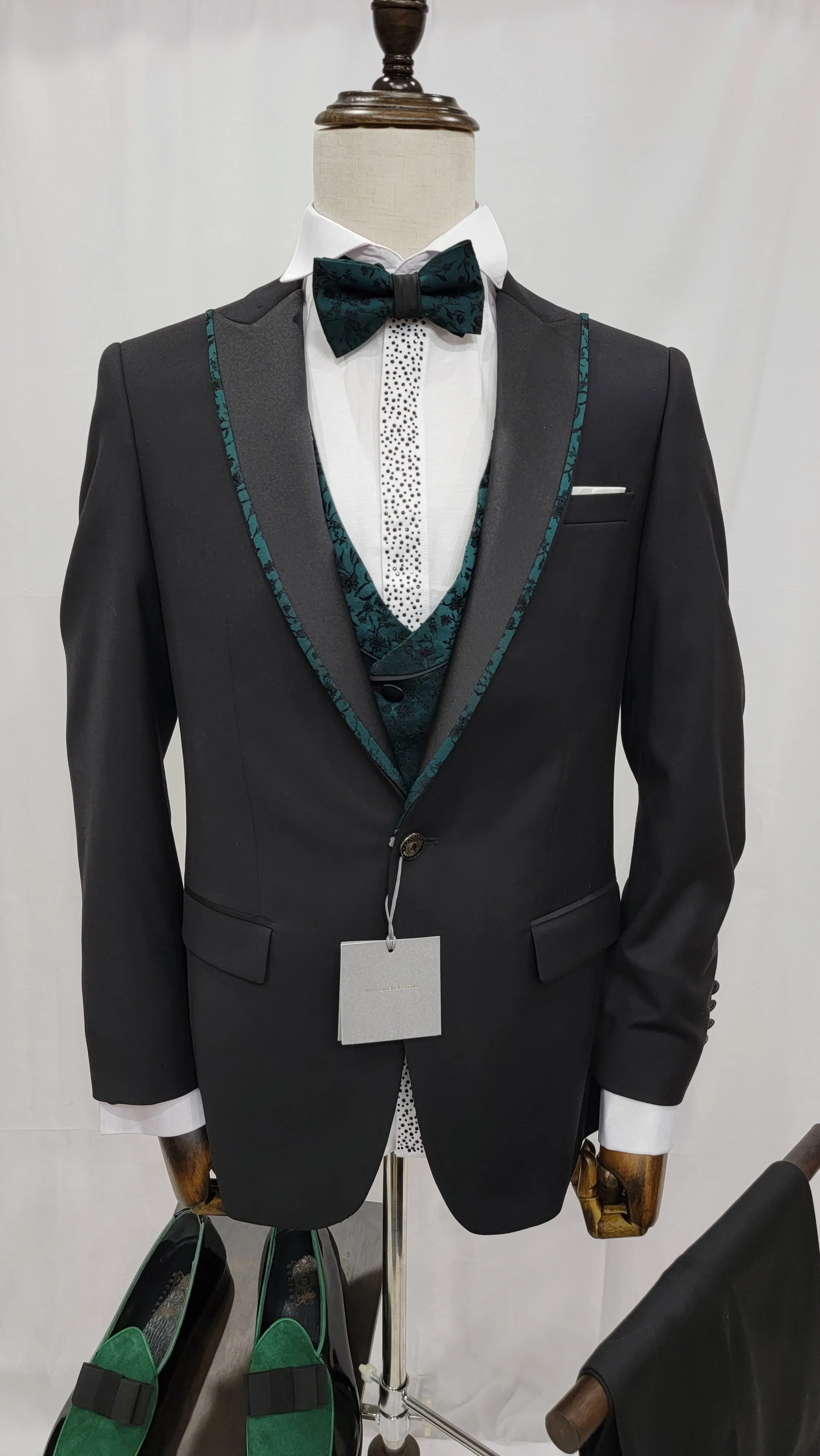 Three-Piece Tuxedo Suit with Contrasting green tapered accent, matching bow tie and Black Pants.