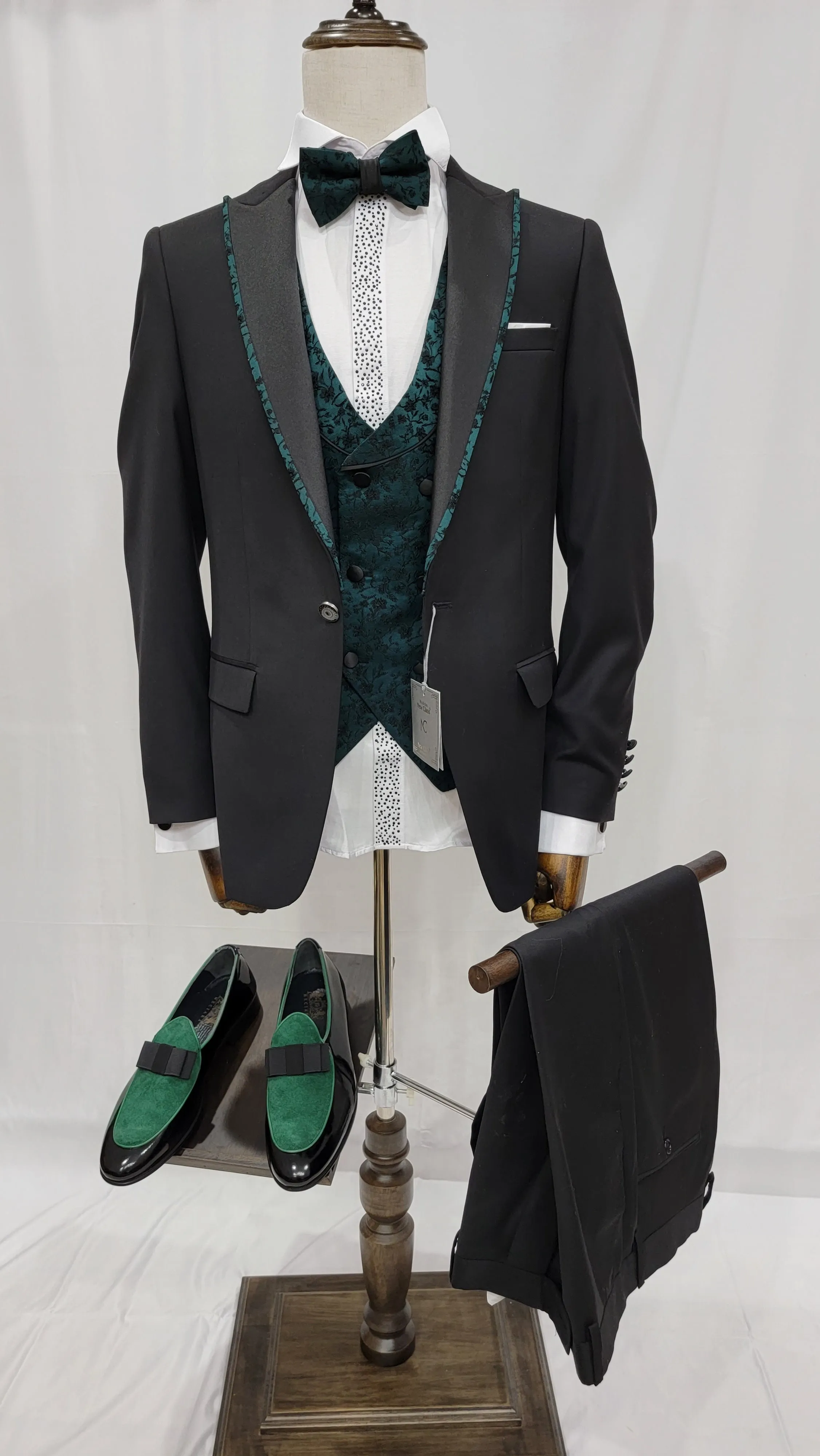 Three-Piece Tuxedo Suit with Contrasting green tapered accent, matching bow tie and Black Pants.