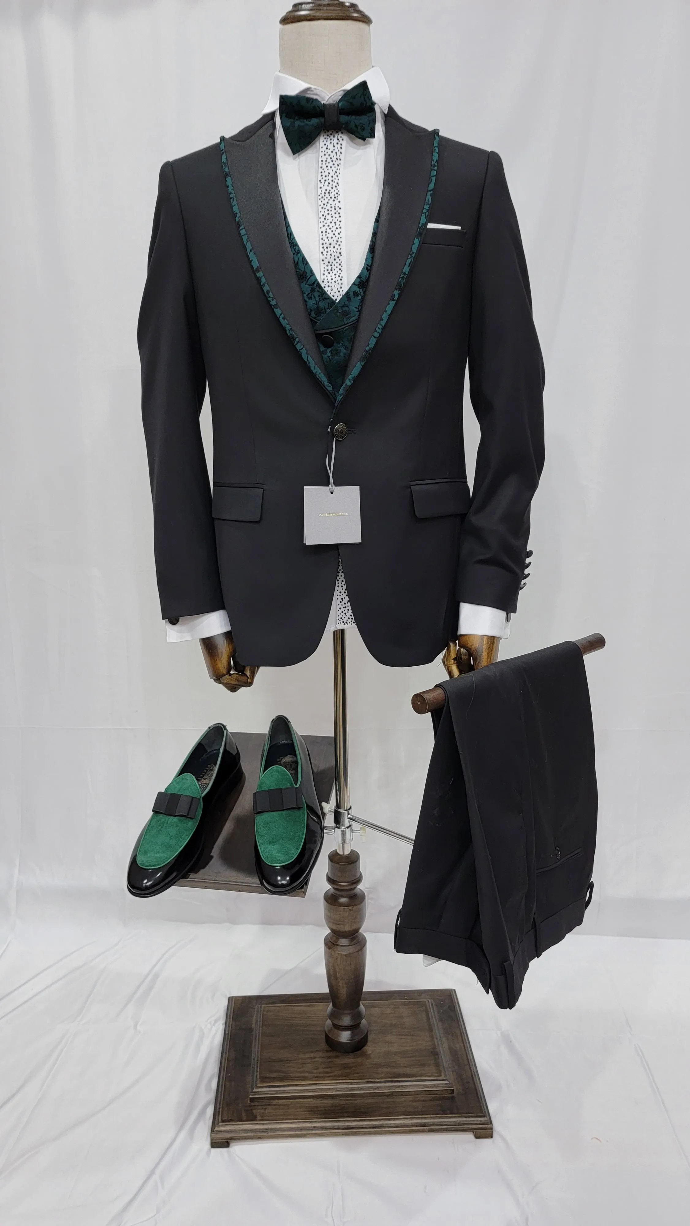 Three-Piece Tuxedo Suit with Contrasting green tapered accent, matching bow tie and Black Pants.