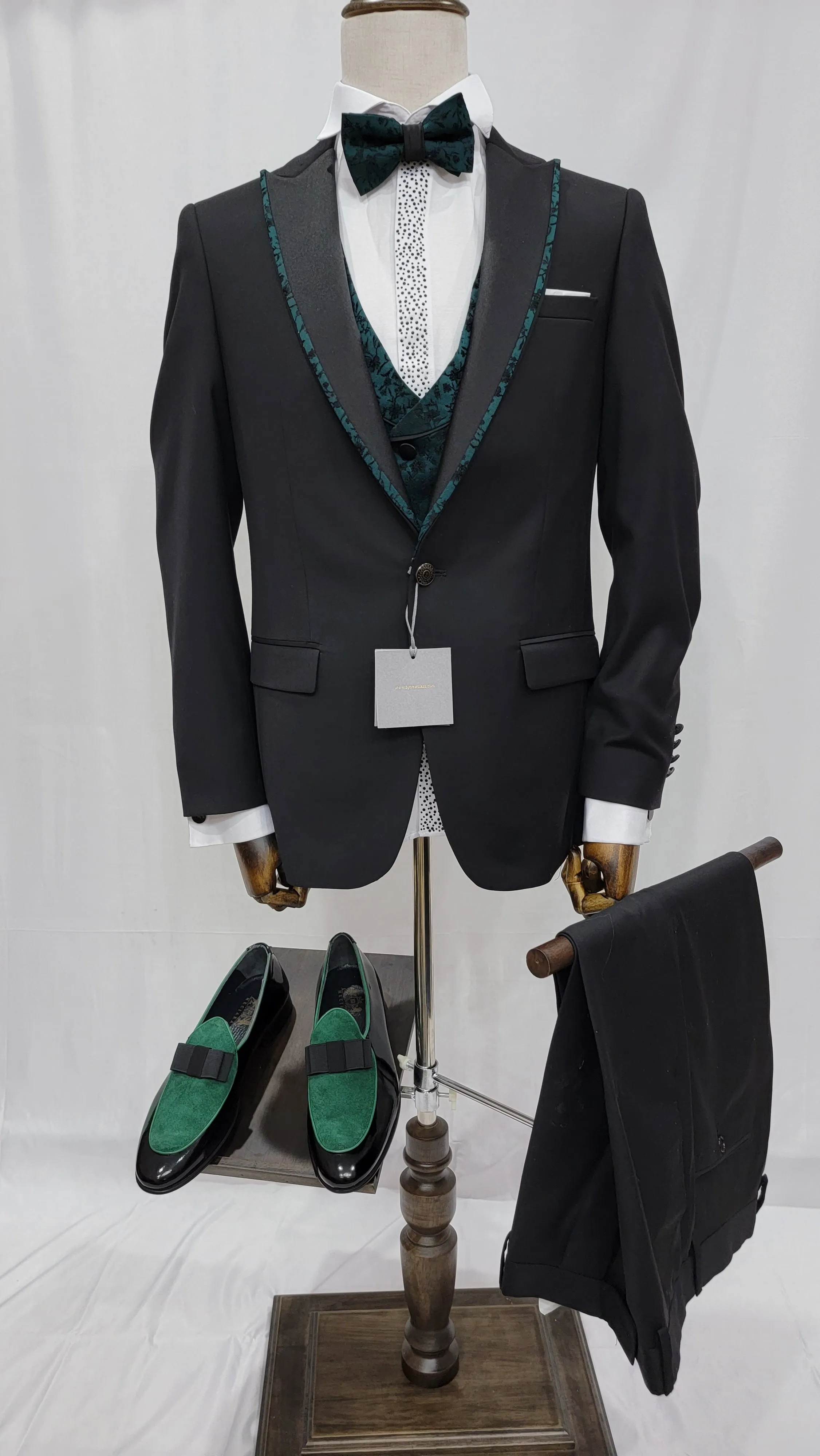 Three-Piece Tuxedo Suit with Contrasting green tapered accent, matching bow tie and Black Pants.
