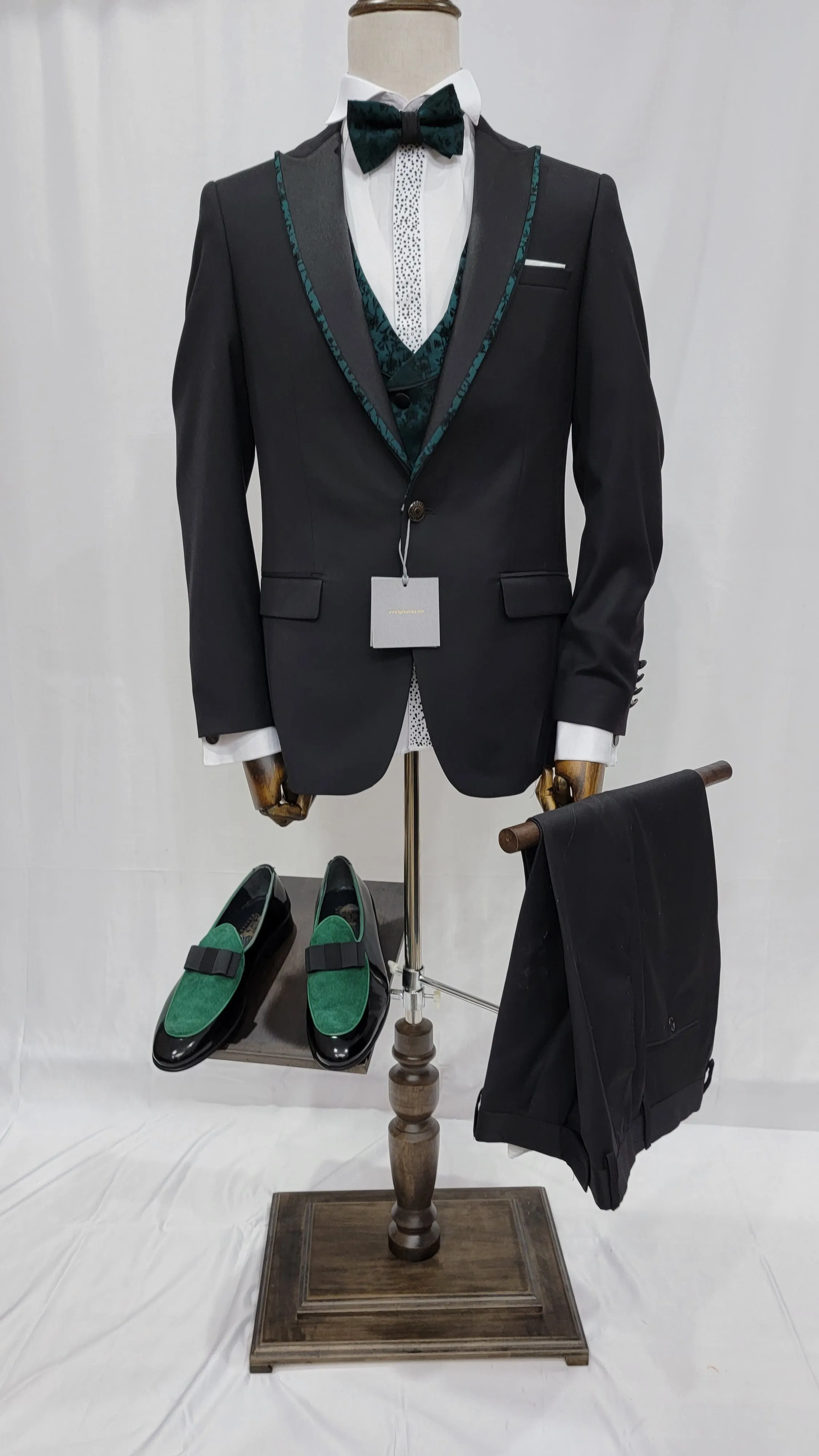 Three-Piece Tuxedo Suit with Contrasting green tapered accent, matching bow tie and Black Pants.