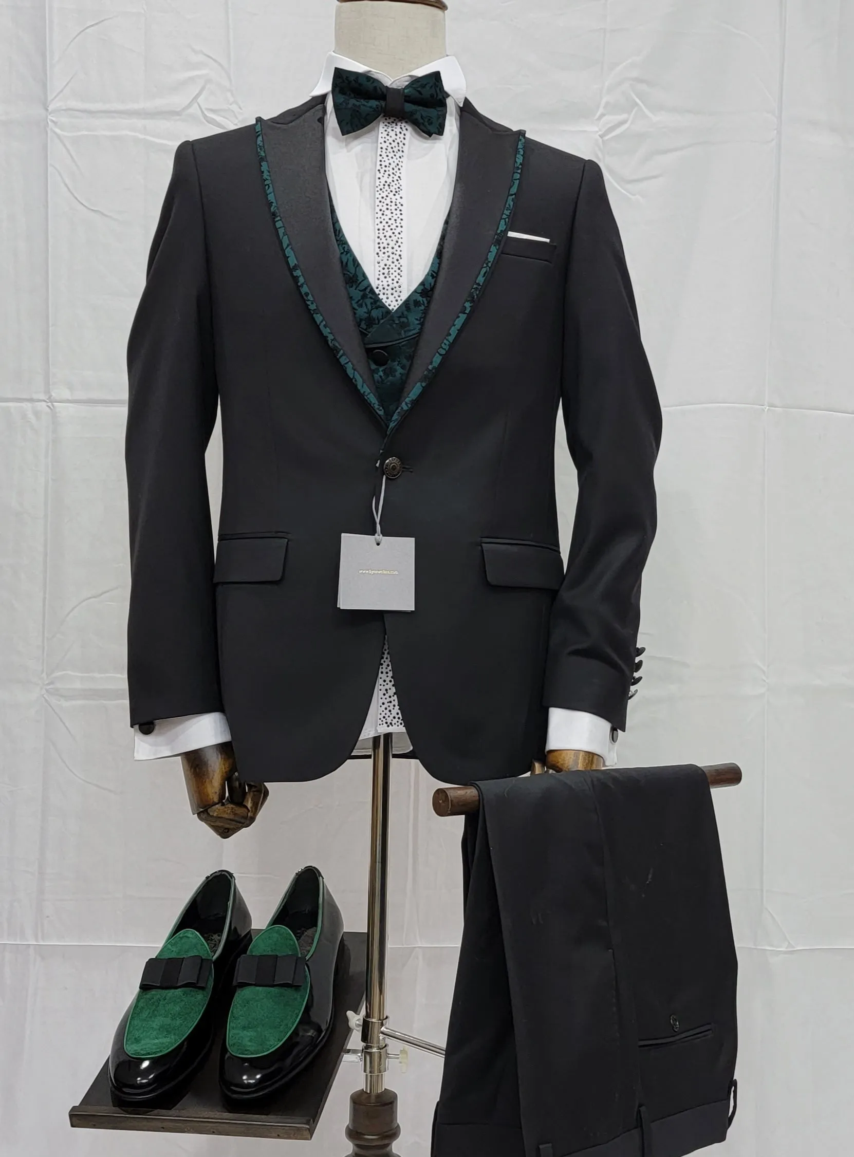 Three-Piece Tuxedo Suit with Contrasting green tapered accent, matching bow tie and Black Pants.